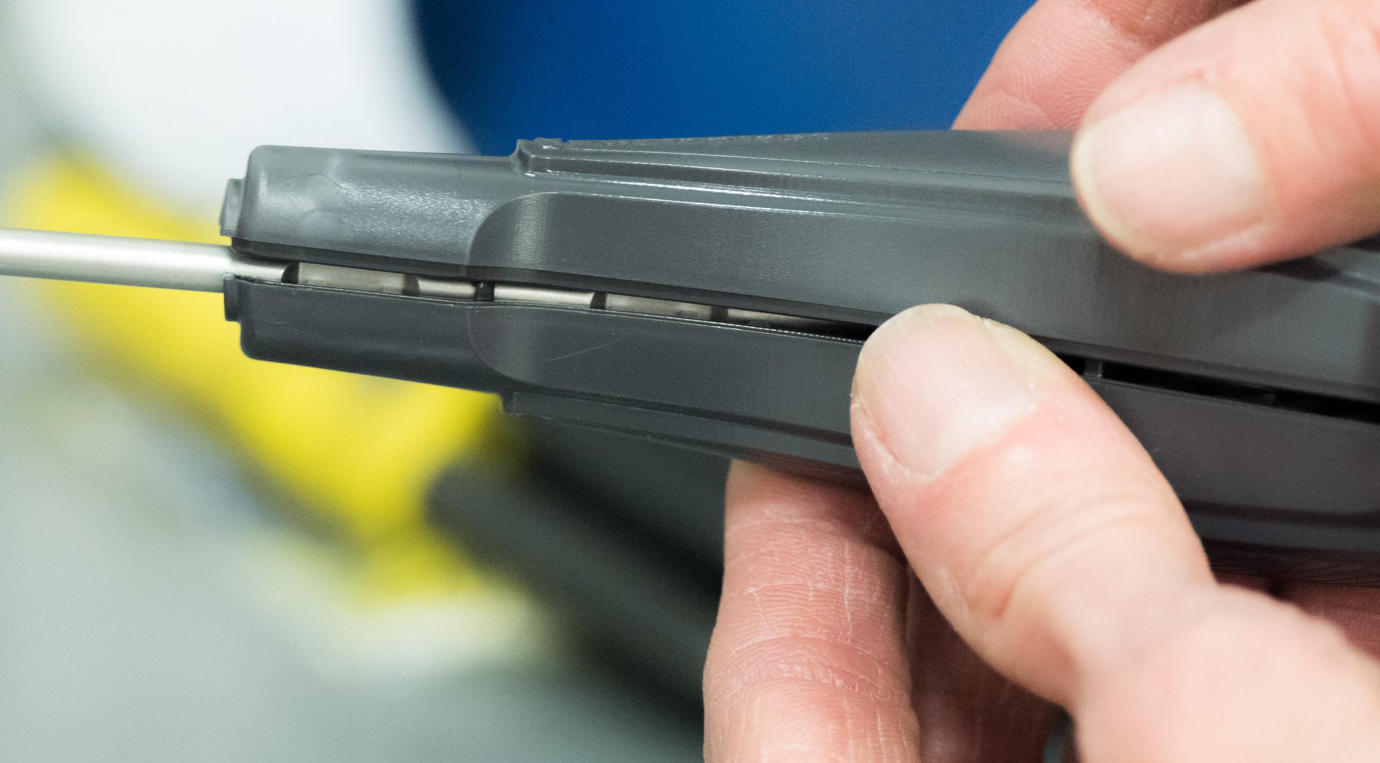 Secondary Operations technician assembling an injected molding handle over metal insert.