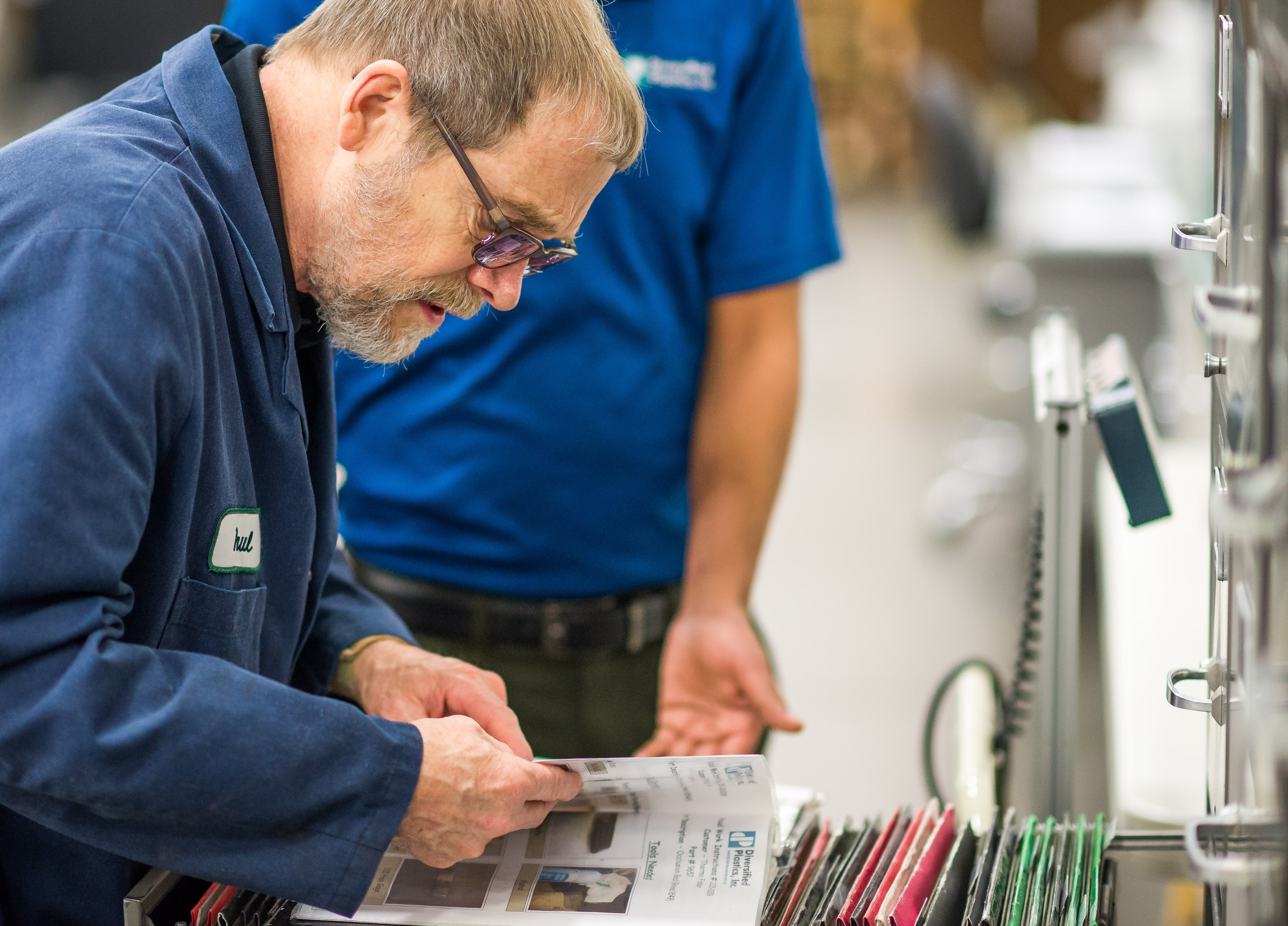 Aprios employee owner looking through filing cabinet